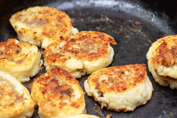 Meat sizzling in a frying pan for a delicious dish