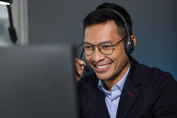 Telephone operator works with computer in office and talks with customers. Businessman working on...