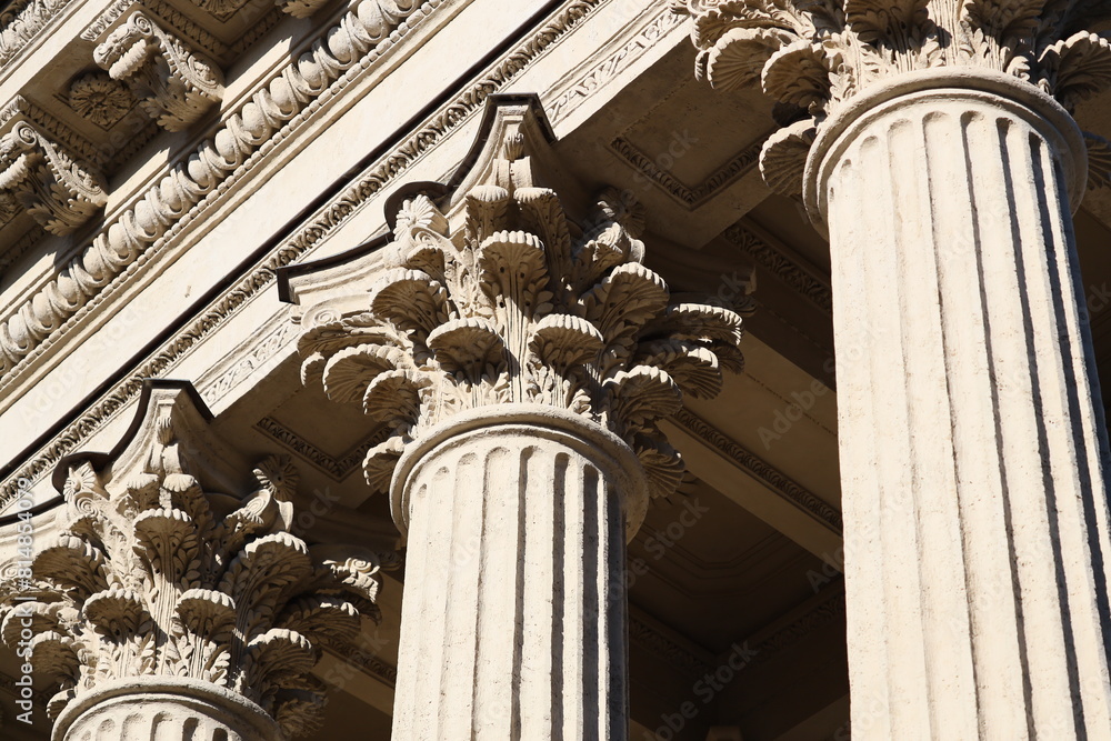 Poster Architectural detail of a building with columns and a clock, suitable for business and urban themes