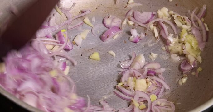 Saut&eacute; frying tossing tomato onion garlic cumin red dry chilli spice in hot oil saucepan cooking for dal tadka bagar 