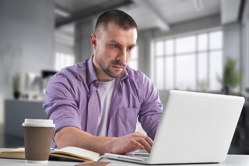 Fototapeta premium Young successful businessman at workplace office
