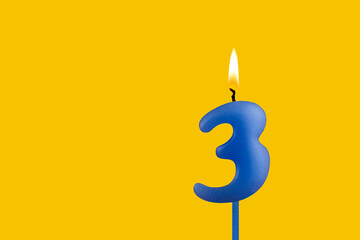 Blue candle number 3 - Birthday on yellow background
