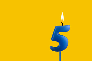 Blue candle number 5 - Birthday on yellow background