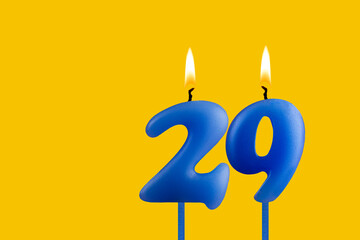 Blue candle number 29 - Birthday on yellow background