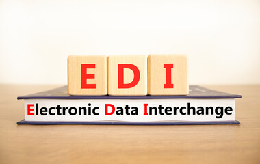 EDI electronic data interchange symbol. Concept words EDI electronic data interchange on blocks and book. Beautiful white background. Business and EDI electronic data interchange concept. Copy space.