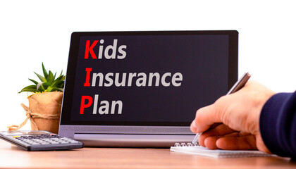 KIP kids insurance plan symbol. Concept words KIP kids insurance plan on beautiful black tablet. Beautiful white background. Businessman hand. Business KIP kids insurance plan concept. Copy space.