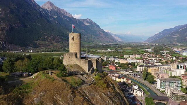 Martigny, Switzerland: Aerial drone footage of the B&acirc;tiaz medieval fort overlooking Martigny city in Canton Valais in the Swiss alps.