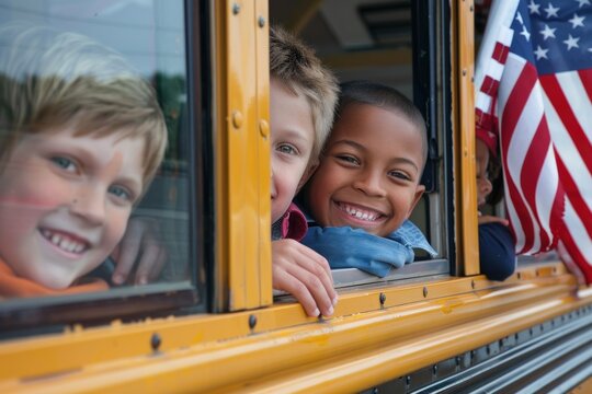 Two young boys, Caucasian and African American, smiling with an American flag in a school bus window.