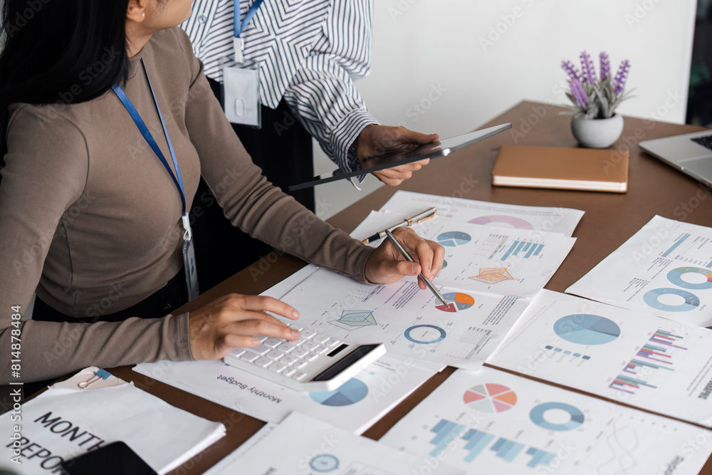 Aufkleber business professional analyzing data and report with digital tablet and calculator. concept of teamw