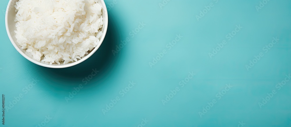Poster top view of a bowl of boiled rice on a colorful background providing ample space for text in the ima