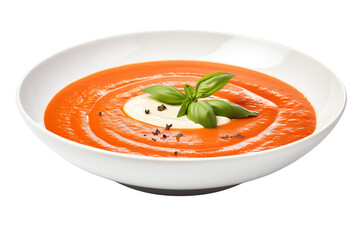 Creamy tomato soup with basil leaves and spices in a white bowl.