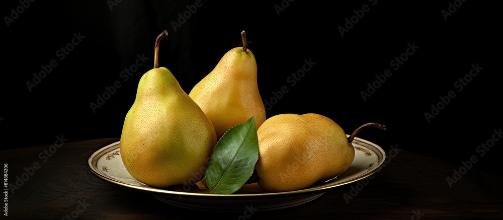 Poster a copy space image featuring three ripe pears arranged on a plate against a dark background