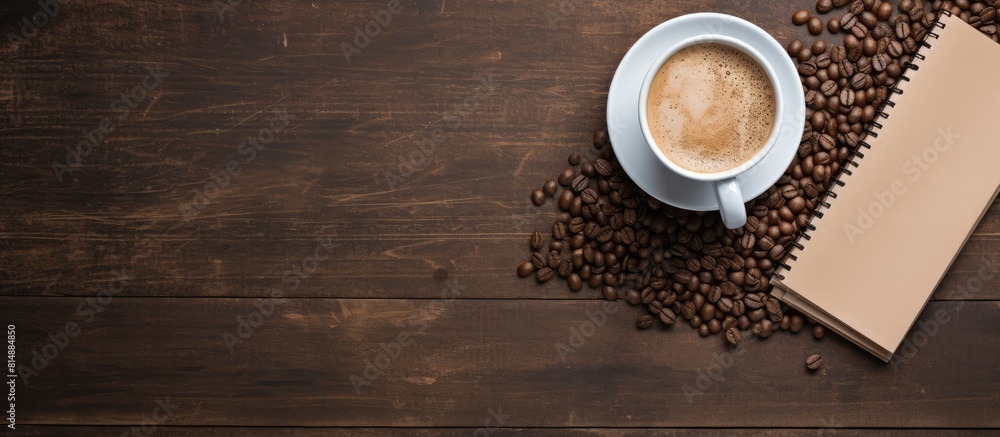 Poster from an elevated perspective there is a pleasing composition of a notebook keyboard and a cup of cof