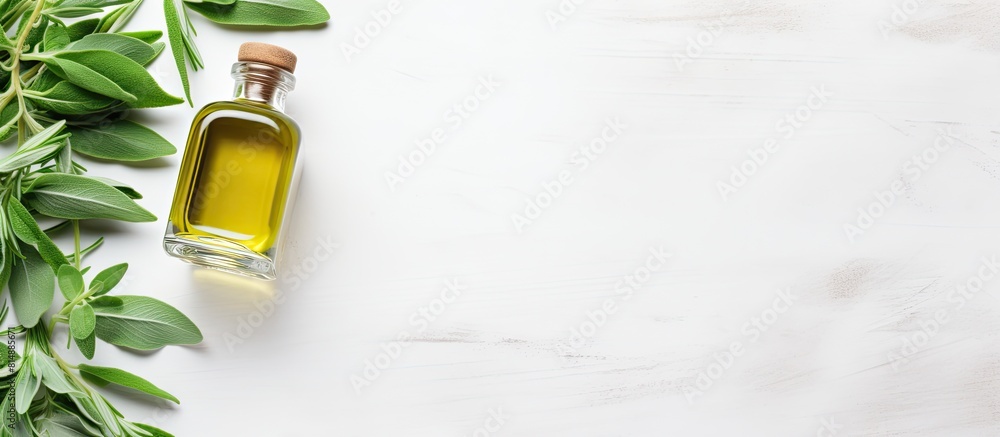 Poster a flat lay composition on a light grey table includes bottles of essential sage oil as well as twigs