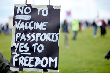 Outdoor, poster and protest of vaccine, sign and community with riot against government and...