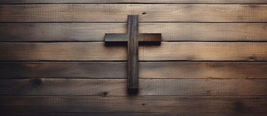 Religious symbol Christian cross on wooden backdrop seen from above with a blank space for textual content Depicting a concept of faith. Copyspace image