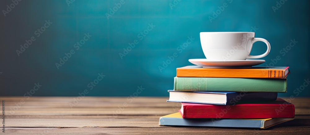 Poster back to school vibes with a stack of vibrant books and a cup resting on a wooden table set against a