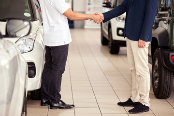 Car, shop and handshake for deal with customer and sale at dealership with insurance or agreement....