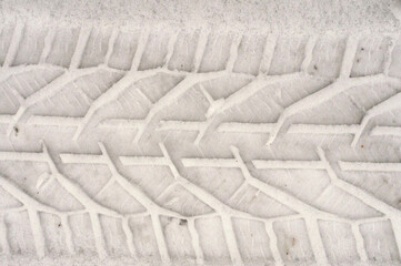 Industrial background. Car tire mark in the snow