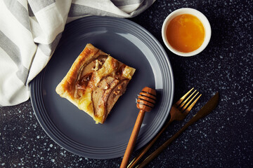 freshly baked homemade pastries. Puff pastry mini tart with pear slices, camembert, honey, walnuts top view