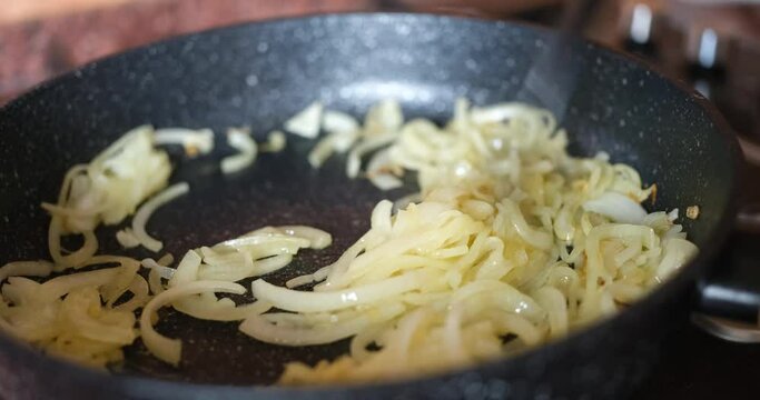 Healthy homemade caramelized onions in pan. Fried onion concept