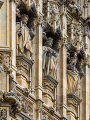 Sculptures covered with bird nets on the exterior of Palace of Westminster (London, England, United Kingdom)