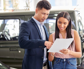 Woman, car dealership and salesman with documents in discussion for and automobile, sale and...