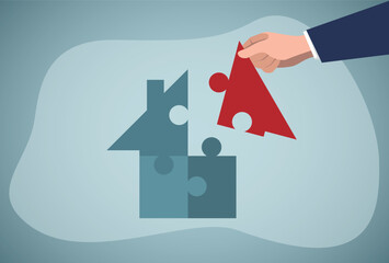 Hands putting puzzle pieces. House loan and business concept.
