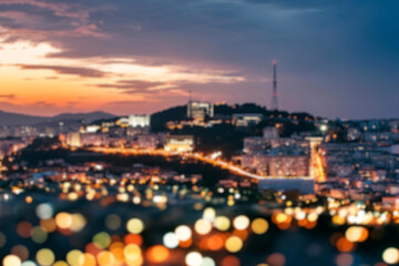 The lights of the night city. Blurred background. Lanterns on the street. big city lights in the twilight evening with blurring. Colorful circles of light abstract. circular bokeh on blue horizon.