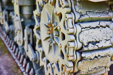 Close-Up of Weathered Military Tank Tracks and Gears, Eye-Level Perspective