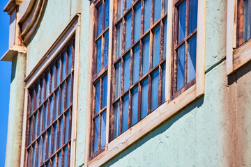Vintage Window on Weathered Blue Building, Low Angle View