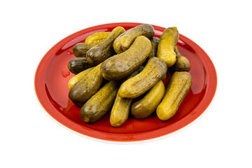 Pickled cucumbers on a red plate isolated on white