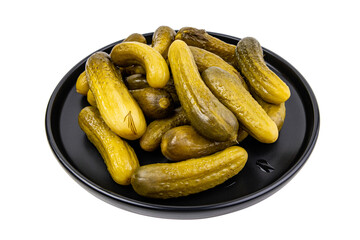 Pickled cucumbers on a black plate close-up isolated on white