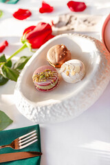 A stack of macarons. Spring composition of macarons with flowers.
