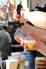 bartender s hand pours fresh draft beer into a glass during a festiva