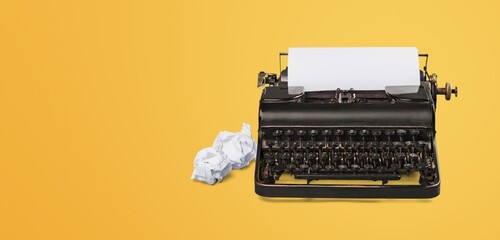 Vintage typewriter with crumpled papers  on desk