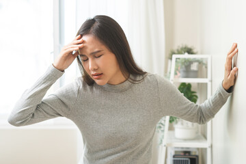 Dizzy asian young woman, girl headache or migraine pain. suffering from vertigo, difficulty...