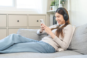 Relaxing concept asian young woman, girl using smart phone listening to music, enjoy song or...