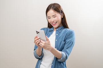 Happy asian young woman using mobile smart phone, read good news online, laugh excited getting...