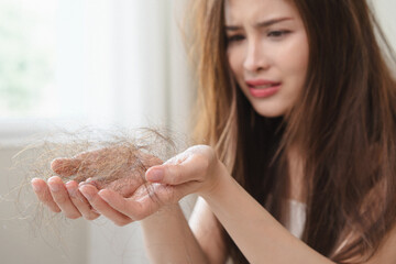 Serious, worried asian young woman, girl holding, show damaged loss hair, problem after brushing,...