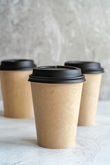 Paper cups with black lids on light background
