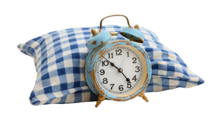 Vintage retro classic rustic blue alarm clock or watch leaning on a pillow isolated on transparent background. Morning early wake up time, snooze, tired