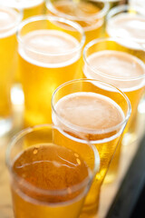 Amber lager beer in glasswares which are prepared for the party event. Refreshment drinking, close-up and selective focus. 