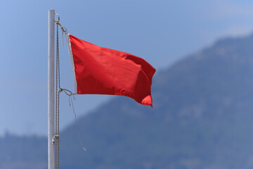 Turkish flag, on a red background white star and moon. Turkish flag flies in the wind against the backdrop of Istanbul