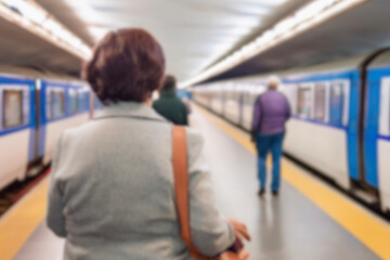 Abstract blurred of passengers walking on walkway at railway station use for the background. Blurred people waiting for subway at station, transportation background. background of people in subway