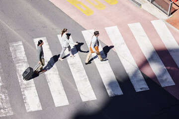 Business, people and crosswalk from street to commute work, journey and traffic on road for transport in morning. Crowd, man and woman walking to travel, safety and trust to airport in Los Angeles