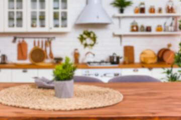 Blurred kitchen background, mockup, display for product advetising. interior of light kitchen with white counters, dining table and big window, blurred view. Simple and fashionable dining kitchen