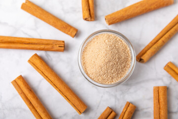 Cinnamon sugar on a texture background. Homemade cinnamon sugar in a bowl on background. Brown sugar. Spice mixture for drinks and baking. Place for text. Copy space.