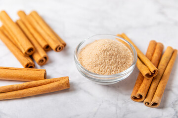 Cinnamon sugar on a texture background. Homemade cinnamon sugar in a bowl on background. Brown sugar. Spice mixture for drinks and baking. Place for text. Copy space.