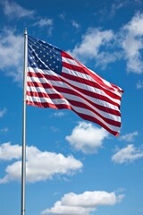 Fototapeta premium Vibrant united states flag gracefully waving under clear skies on a stunningly beautiful day
